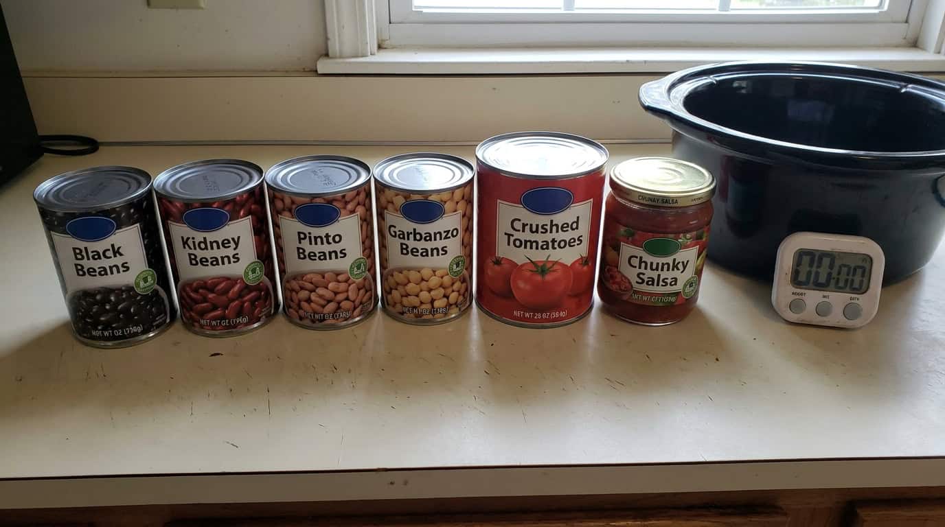 Assorted canned beans and crushed tomatoes on kitchen counter with timer.