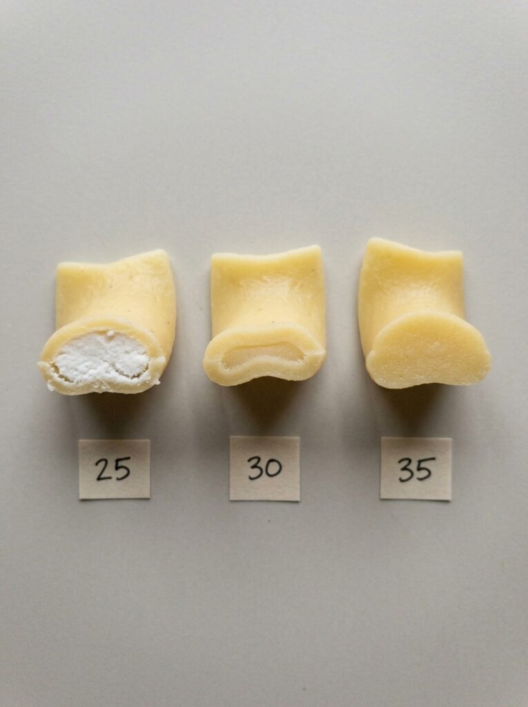 Three egg noodles cut open at 25, 30 and 35 minutes, the white core shrinking to tender